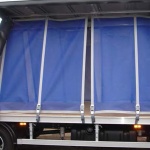 cargo_nets_in_use_on_side_of_trailer_strong_pvc_cargo_net_cargo_net_for_securing_loads_load_containment_trailer_containment_load_securing_nets_rigid_firm_nets