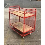 red_picking_trolley_small_and_rigid_with_3_mesh_sides_and_2_swivel_and_2_fixed_castors_also_a_4th_side_above_the_maincompartment_to_allow_the_top_shelf_to_be1